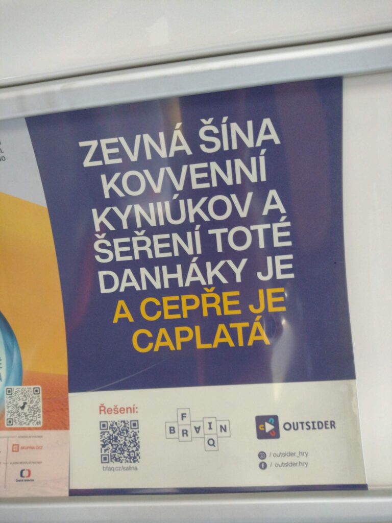 Na plakátu se píše:
zevná šína
kovvenní
kyniúkov a
šeření toté
danháky je
a cepře je
caplatá
Pod textem je QR kód.